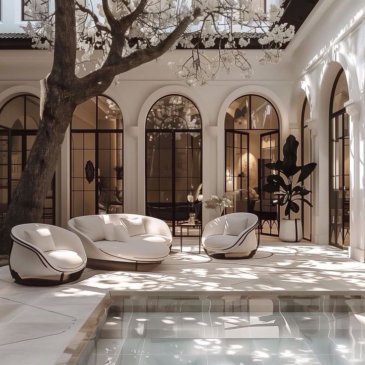 white flower tree, tree in courtyard of building, arch shaped glass windows, classical european architecture, courtyard with pool inside, classical terrace design, tile design nearby pool ,ludhiana, punjab